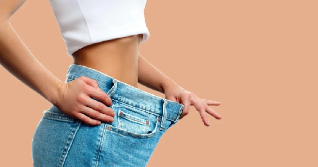 Woman showing loose jeans, after Weight Loss Injections treatment in South Ogden, UT.